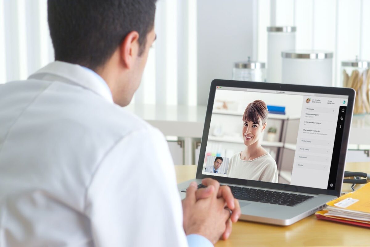 Doctor on a telehealth call on his laptop with a patient